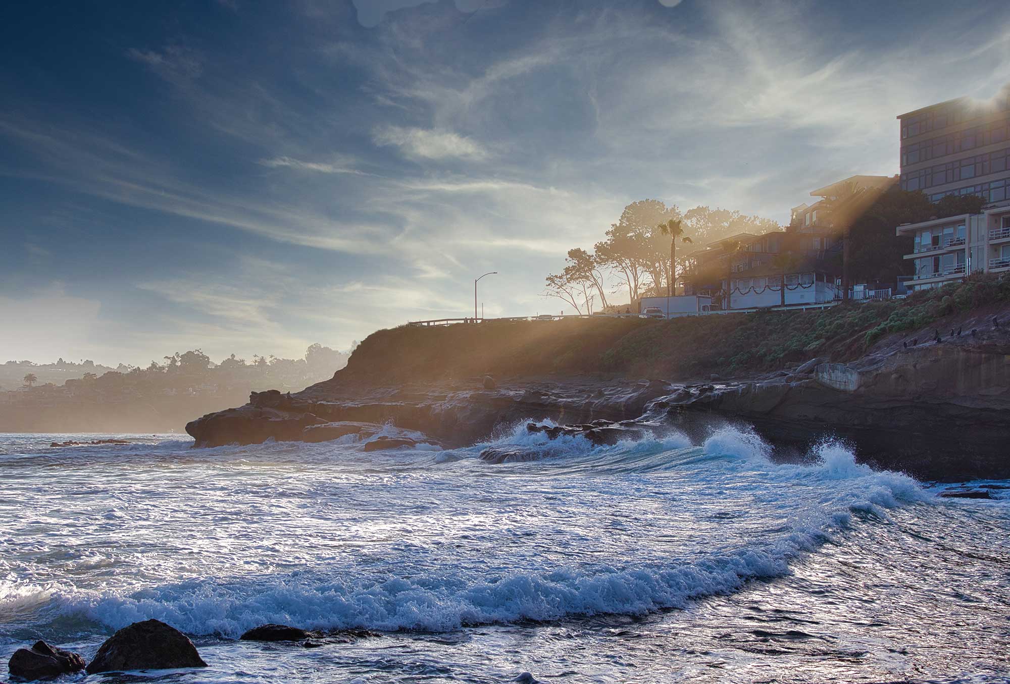 la-jolla-cove-with-sun-rays-over-the-horizon